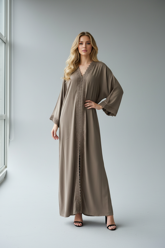 Model with blonde wavy hair wearing sand kimono with black heels